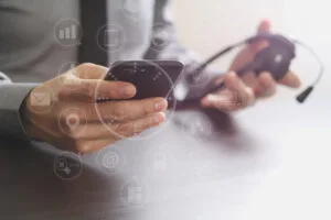 businessman using VOIP headset with mobile phone
