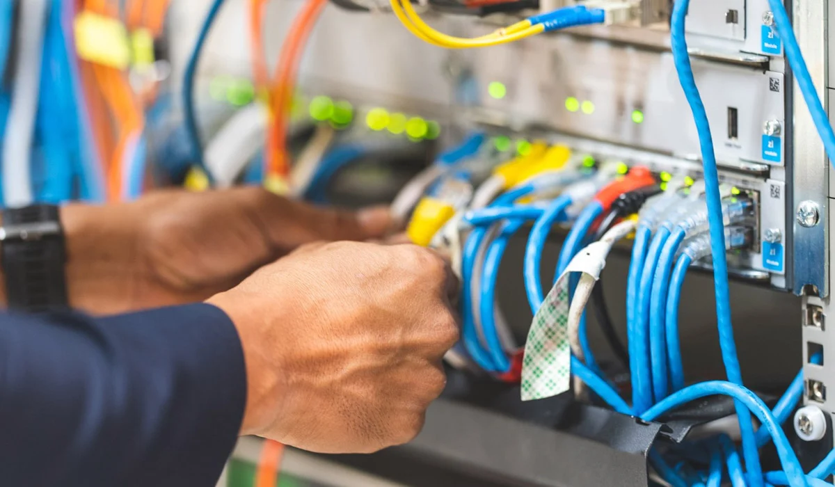 upclose-of-man-working-on-network-cabling